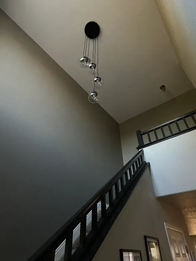 A staircase with a light hanging from the ceiling