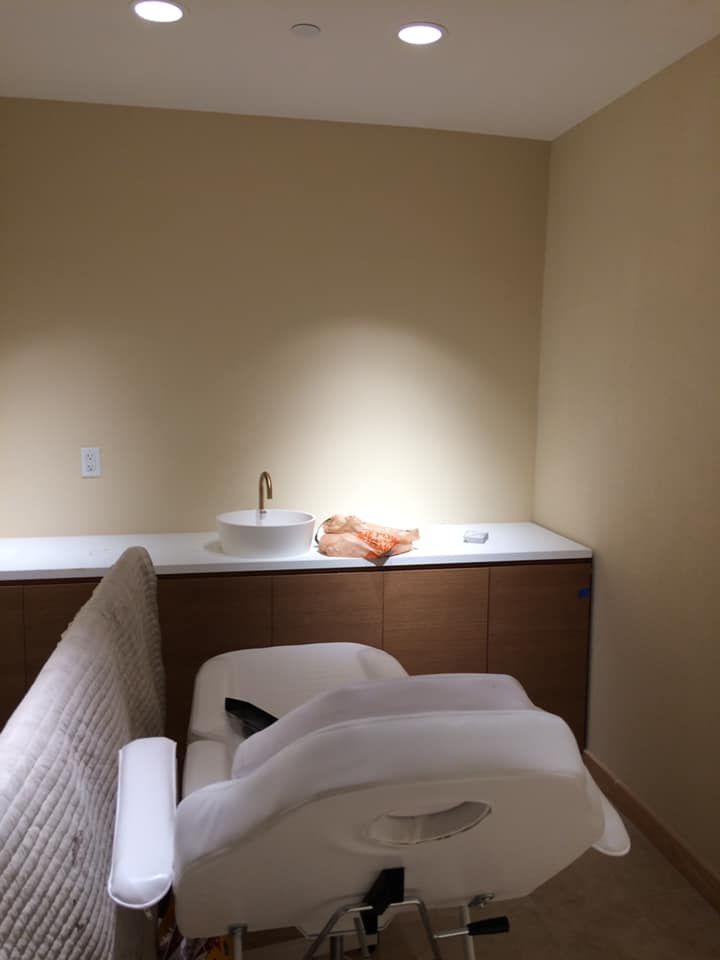 A room with a chair and a sink in it
