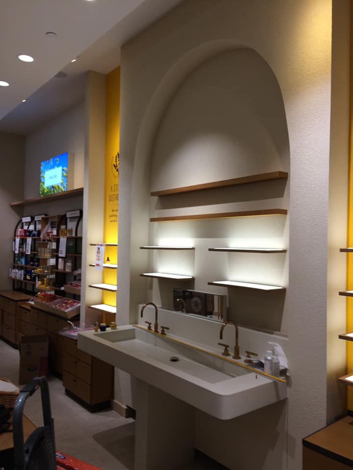 A bathroom with a sink and shelves in a store