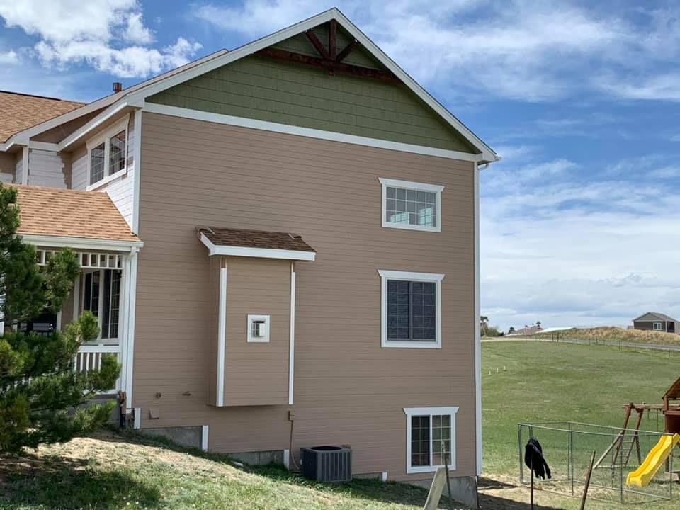 A large house with a playground in front of it.