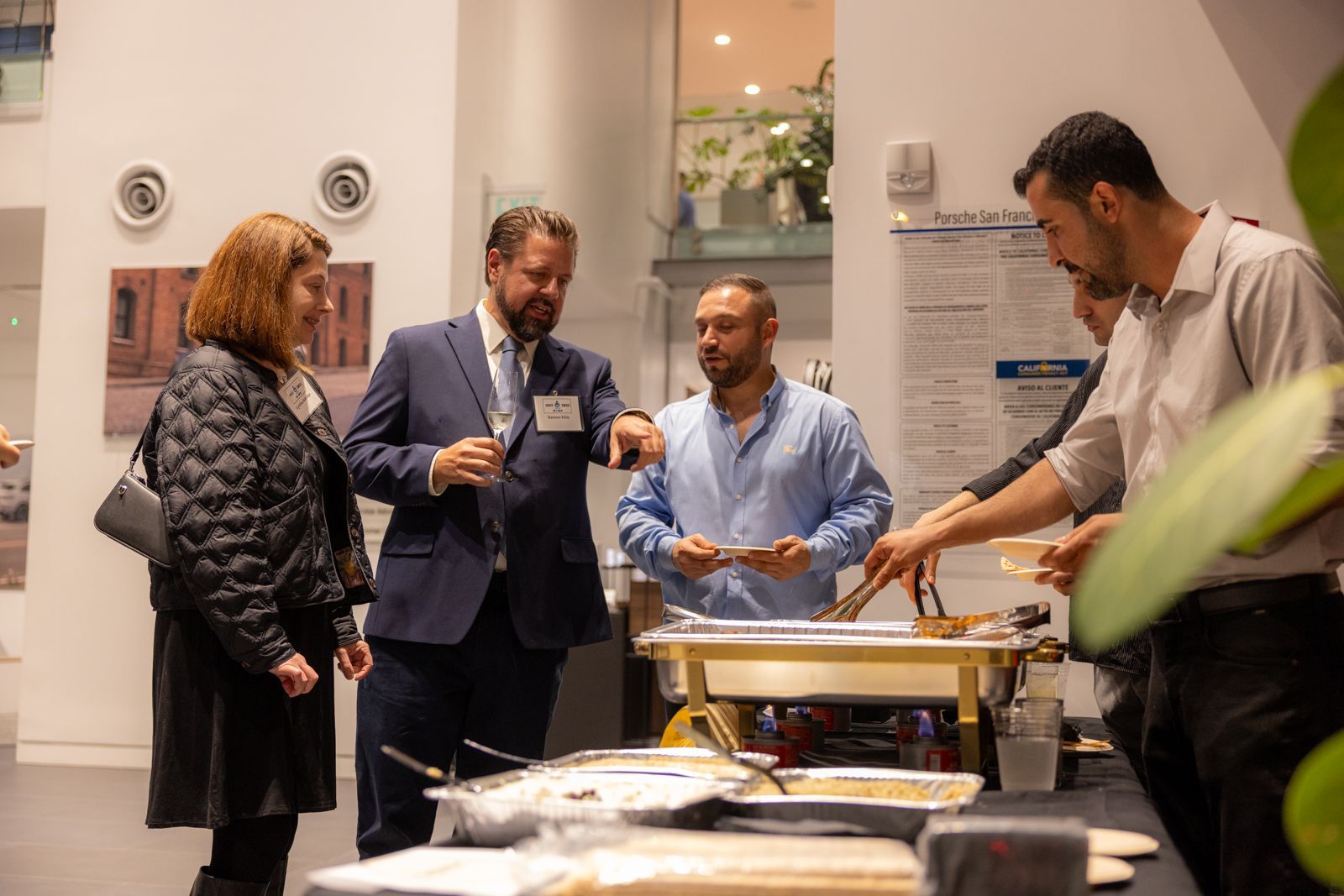People sampling food at a catered event buffet indoors