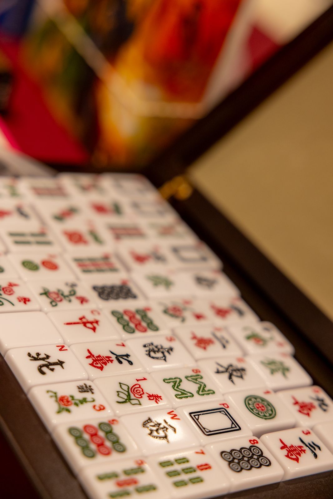 Close-up of a patterned tablecloth with festive holiday and food-themed icons in red, green, and black.