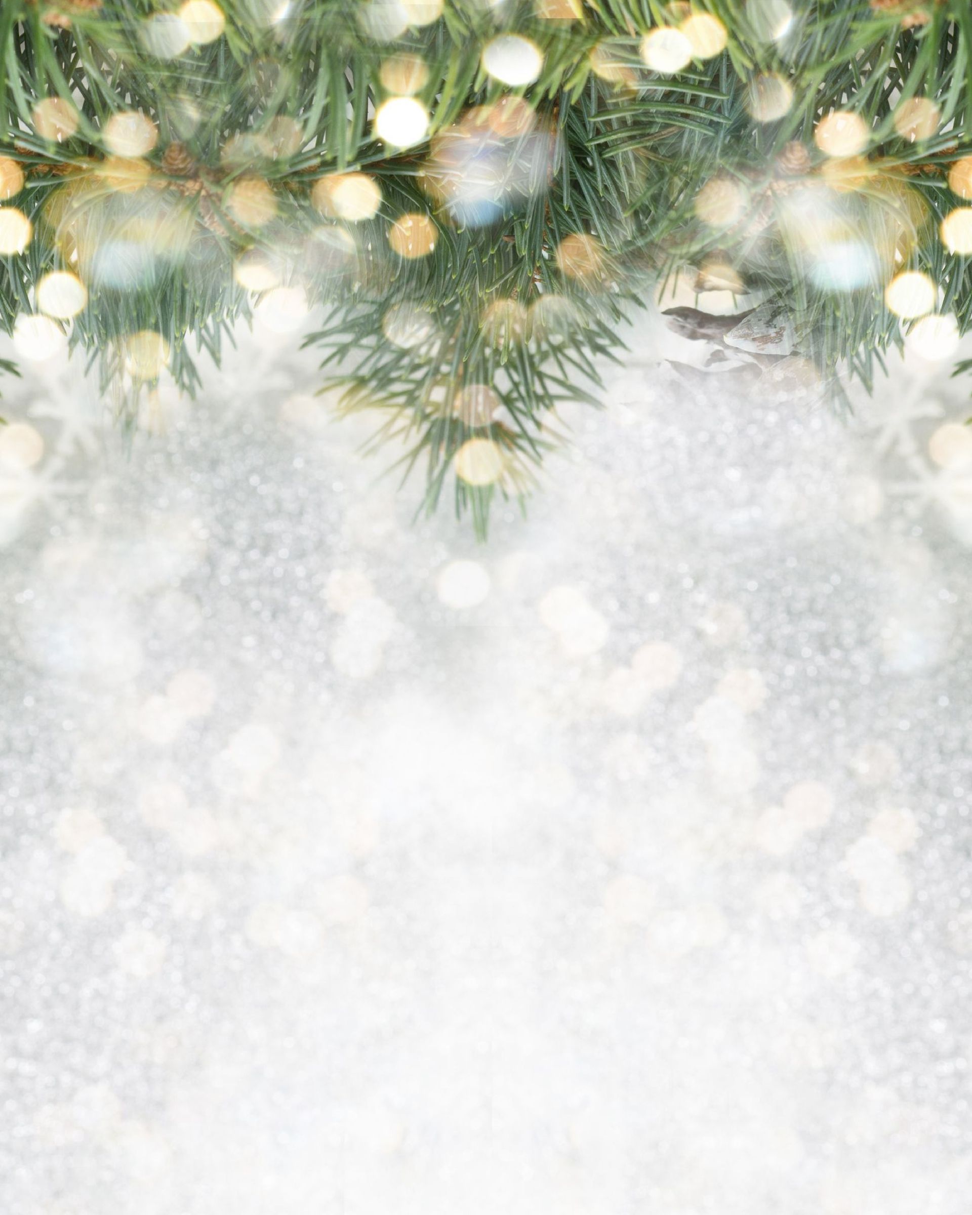 A christmas tree with lights and decorations on a snowy background.