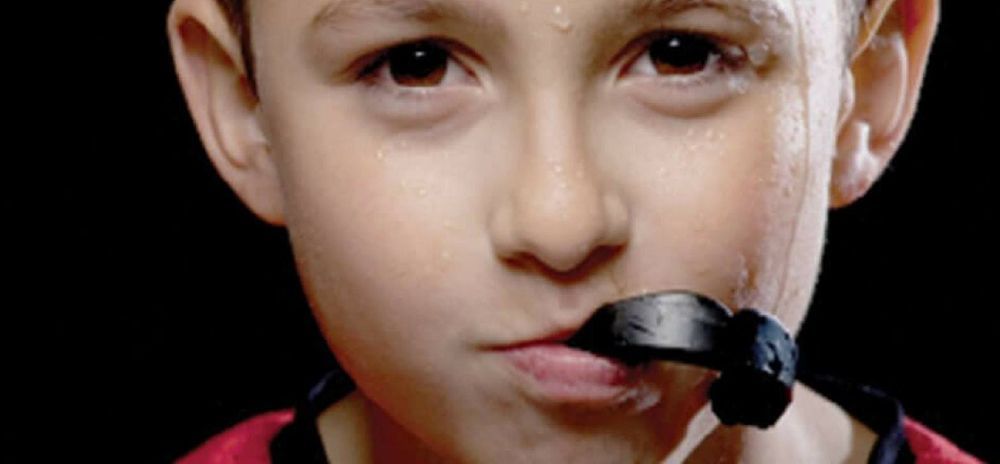 A Young Boy with a Piece of Black Licorice on His Mouth— Ballina Denture Clinic Michael J Parker in Bangalow, NSW