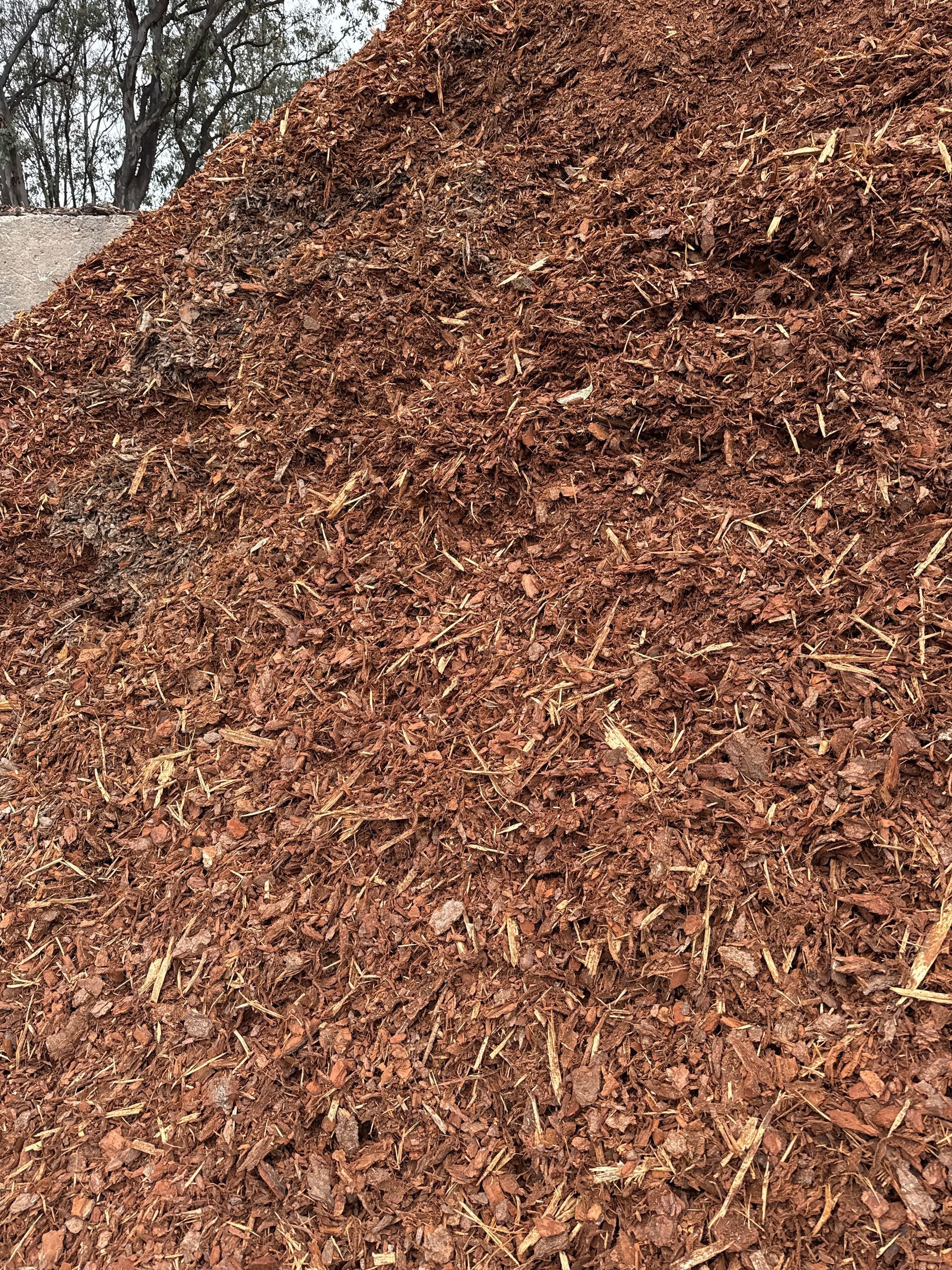 A Large Pile Of Reddish-brown Mulch, Likely Used For Gardening, With A Slight Slope And Some Straw-like Pieces — Wodonga Sand & Soil in Wodonga, VIC