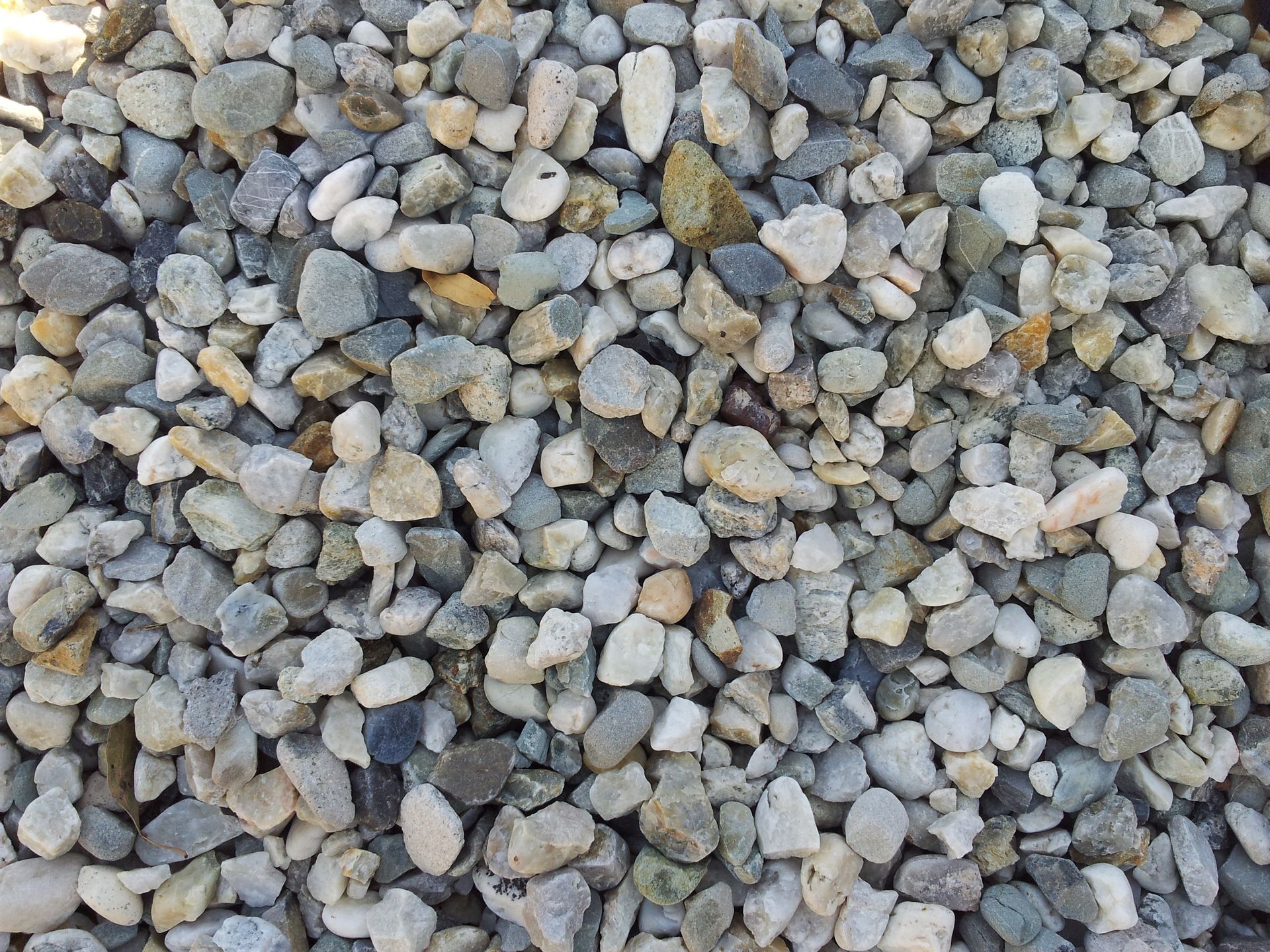 Pile Of Small, Rounded Gray And Tan Gravel Stones — Wodonga Sand & Soil in Wodonga, VIC