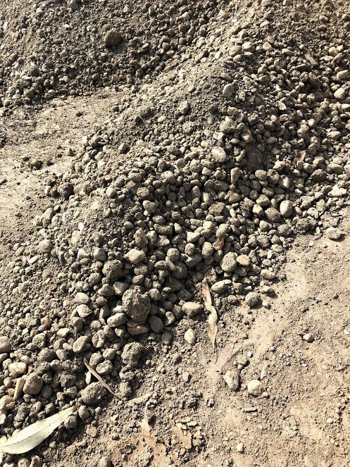 Pile Of Gravel And Dirt On A Sunny Surface, Displaying A Mix Of Light Brown And Grey Tones — Wodonga Sand & Soil in Wodonga, VIC