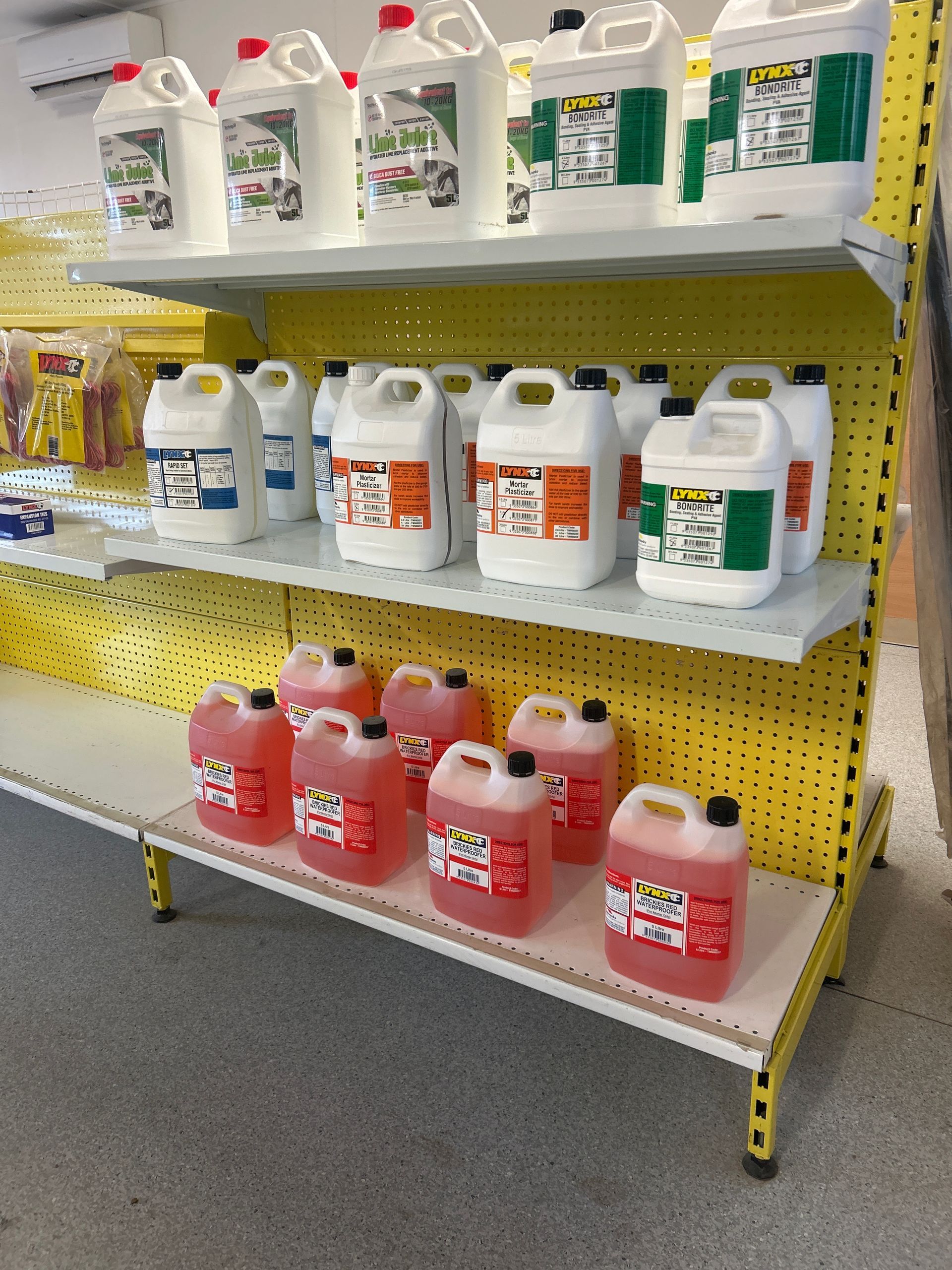 Shelves In A Store Filled With Various Liquid Containers — Wodonga Sand & Soil in Wodonga, VIC