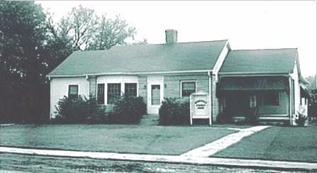 old photo of a small white house