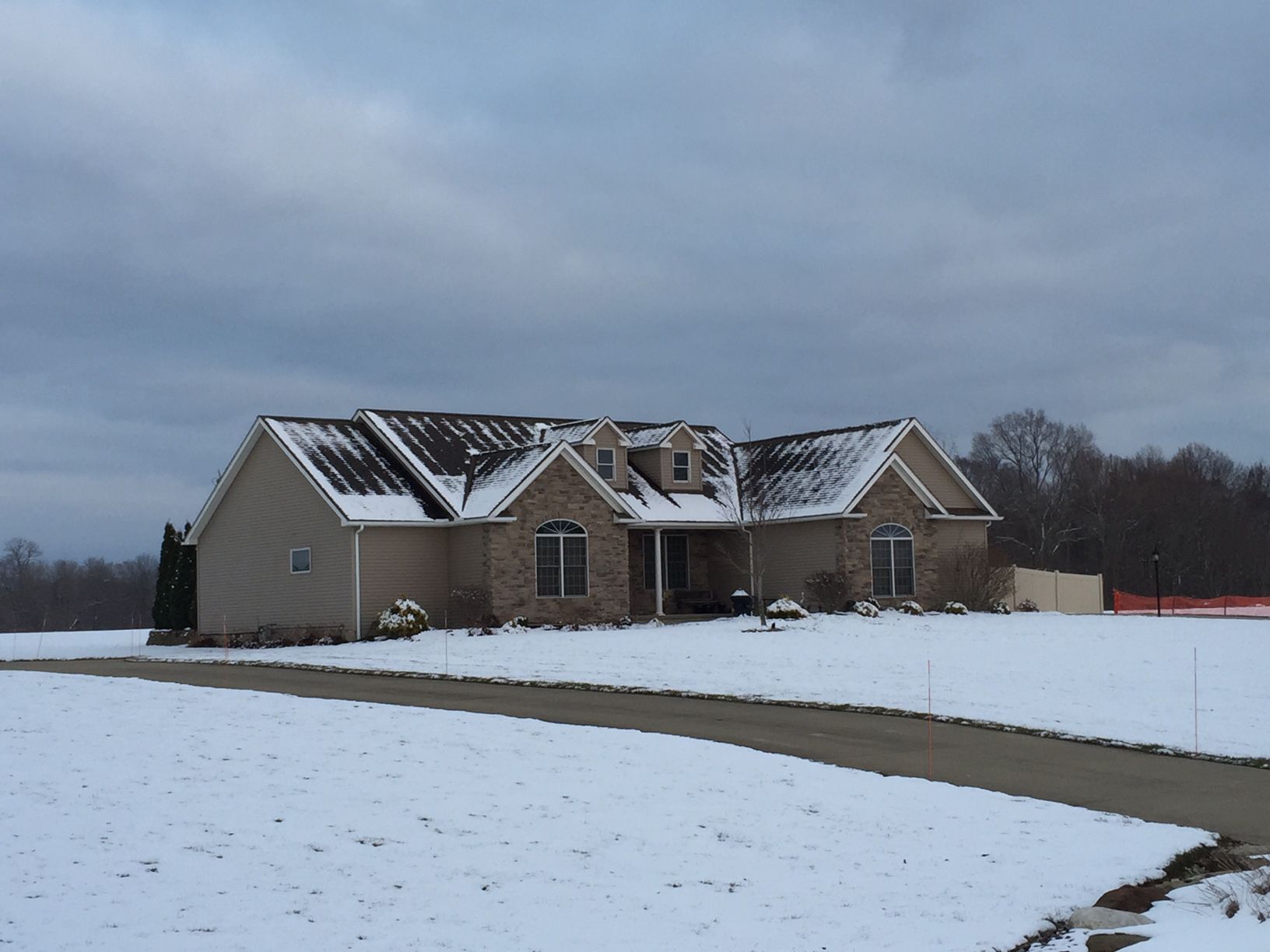 A house in the middle of a snowy field
