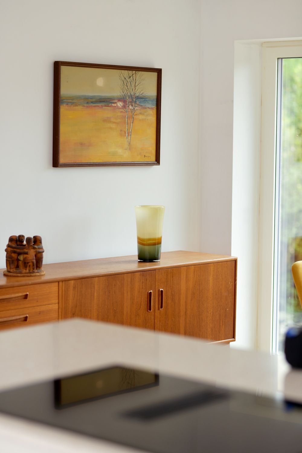 There is a picture on the wall above the stove in the kitchen  in a Large-Scale Retrofitting in East Sussex
