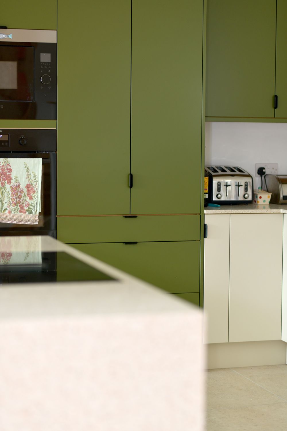 A kitchen with green cabinets , a toaster oven , and a microwave  in a Retrofit Consultancy in East Sussex