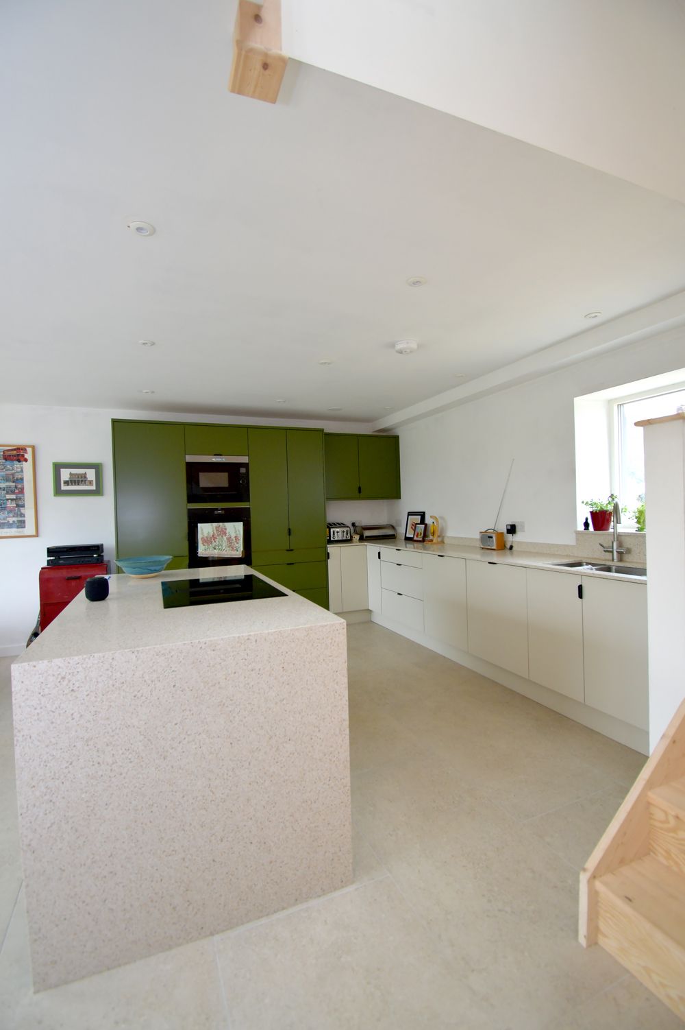 A kitchen with green cabinets and white counter tops  in a Retrofit Consultancy in East Sussex