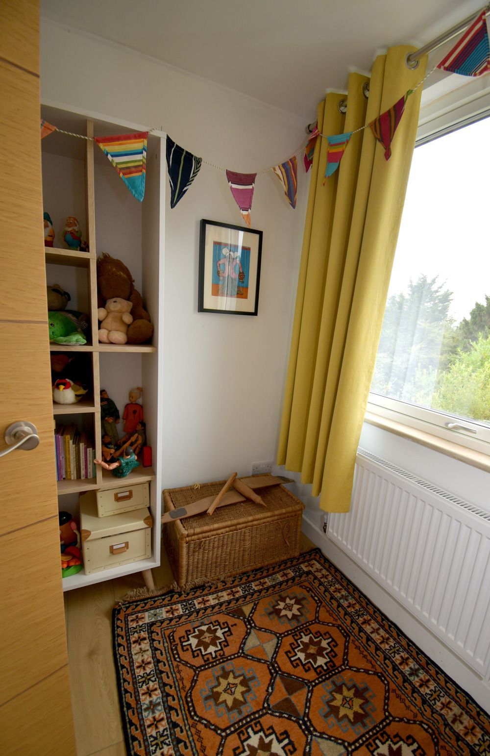 A room with a rug and a window with yellow curtains  in a Retrofit Consultancy in East Sussex