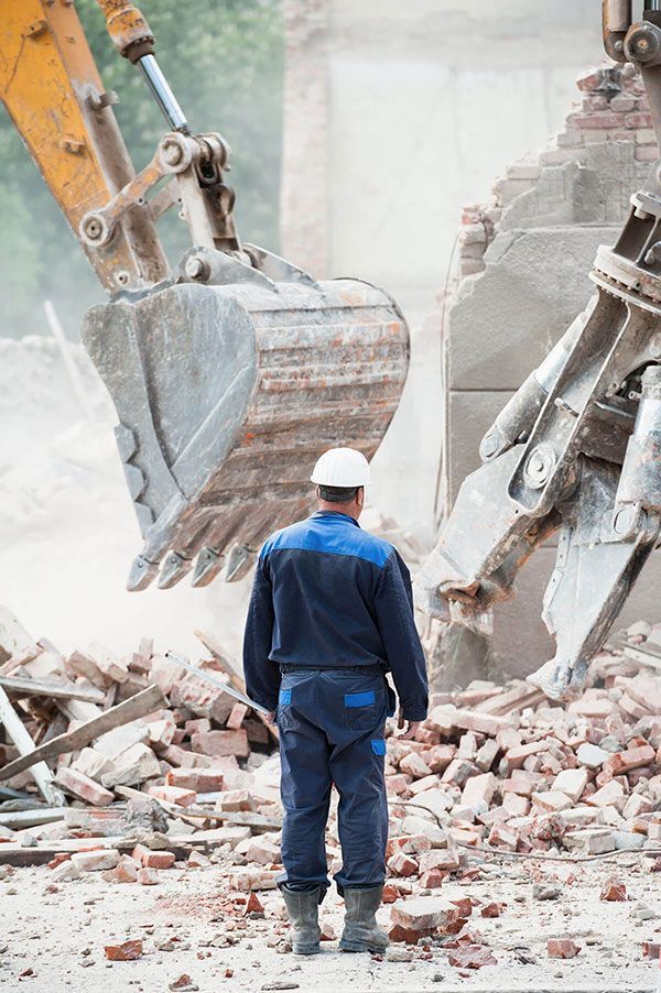 Man At A Demolition Of Building — Efficient Waste Disposal in Gracemere, QLD