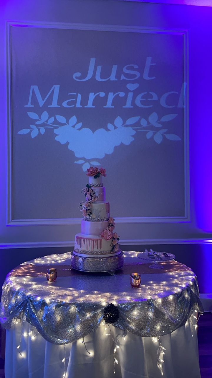 Wedding cake on a table with fairy lights; 