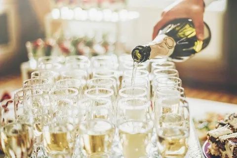 Pouring Champagne In Wine Glasses