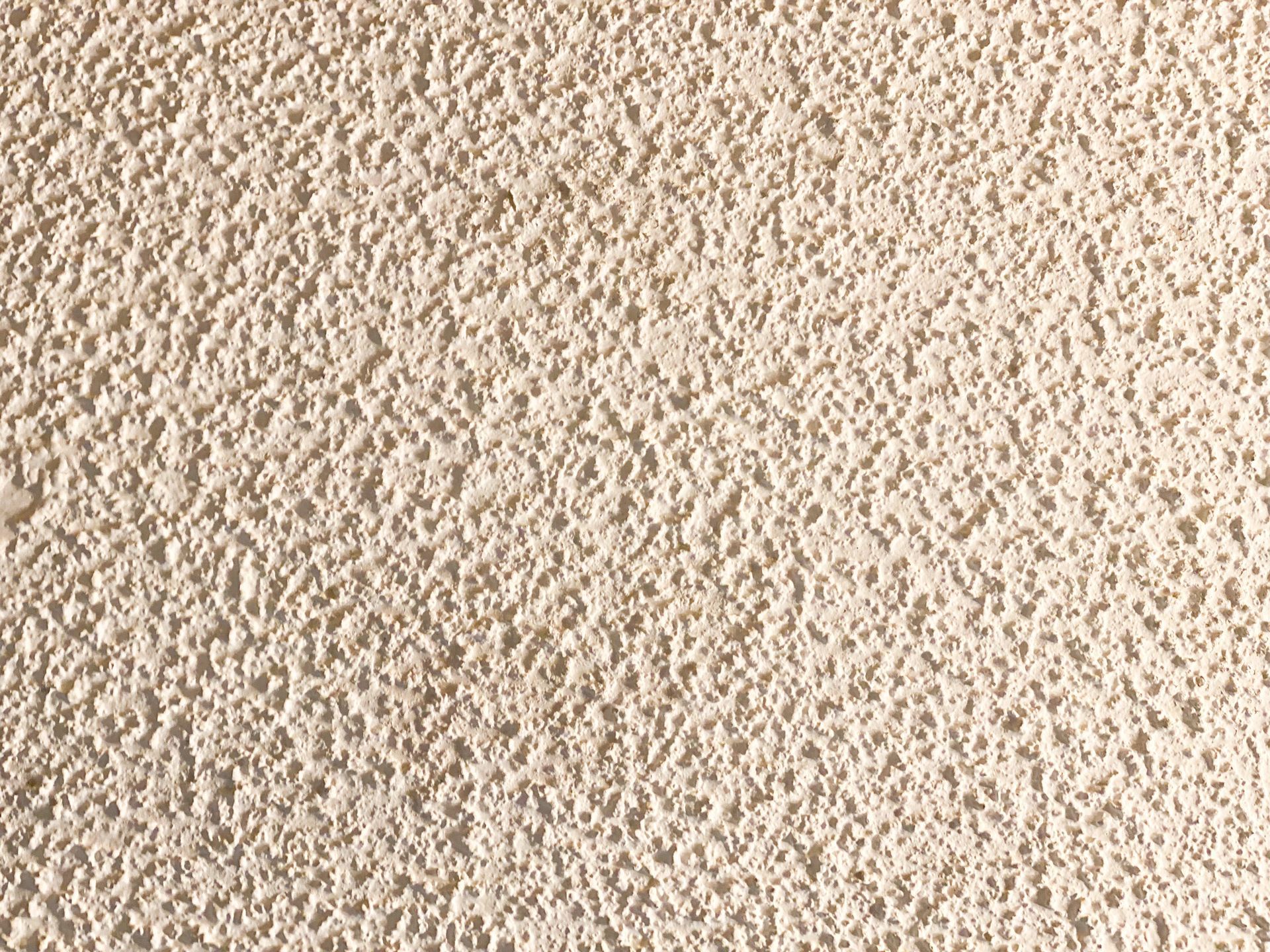 Textured beige stucco wall.