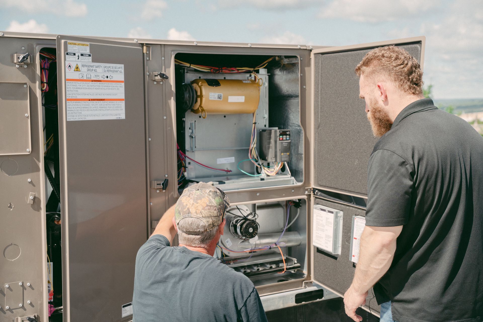 On Track HVAC Team Working on a Commercial Rooftop Unit
