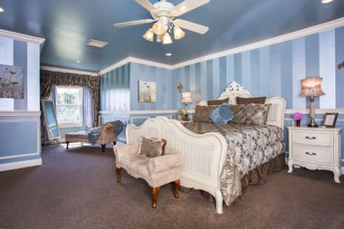 king bed suite with chaise in front of window