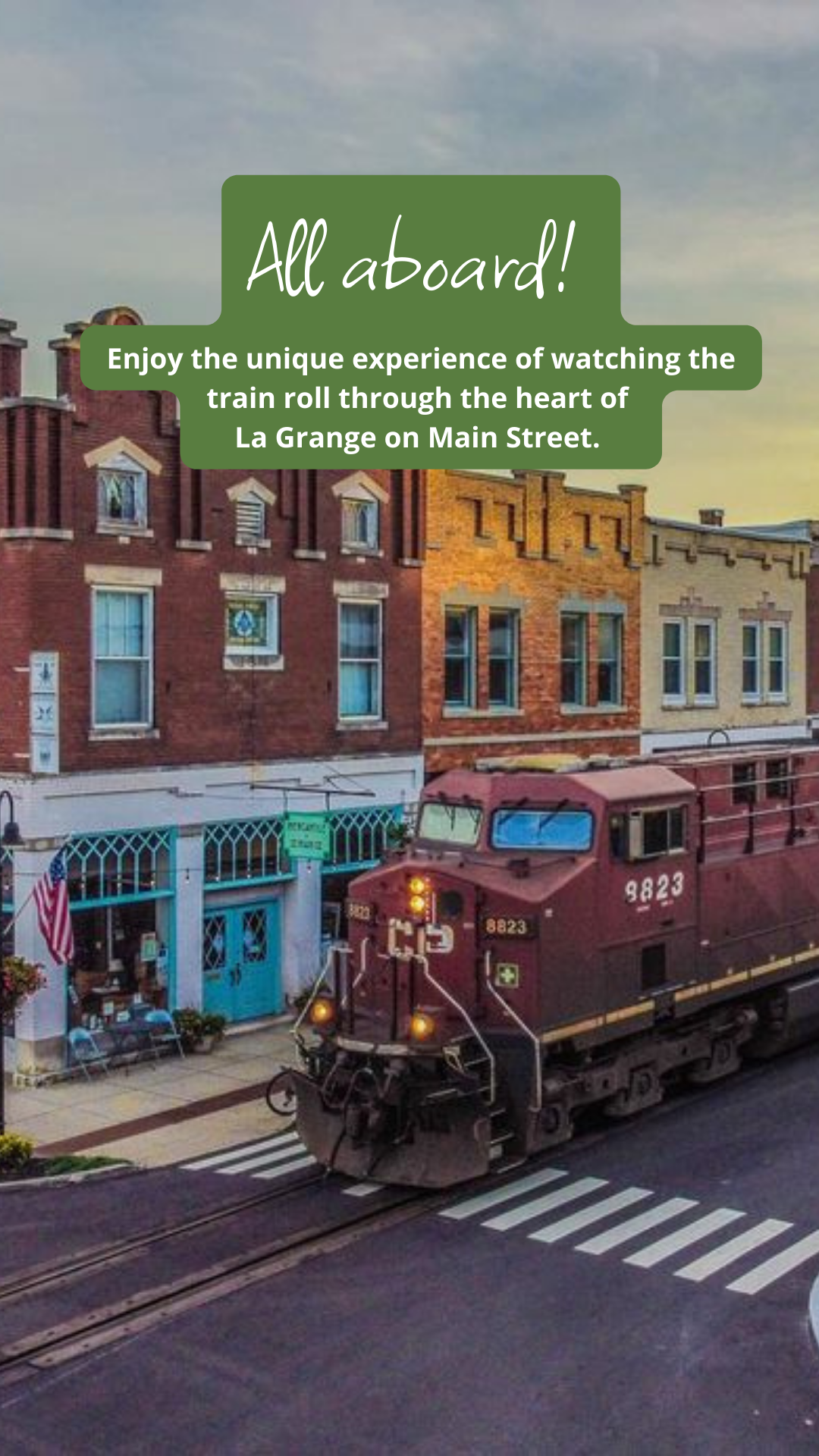 Train rolling through downtown La Grange on Main Street. Text overlay: 