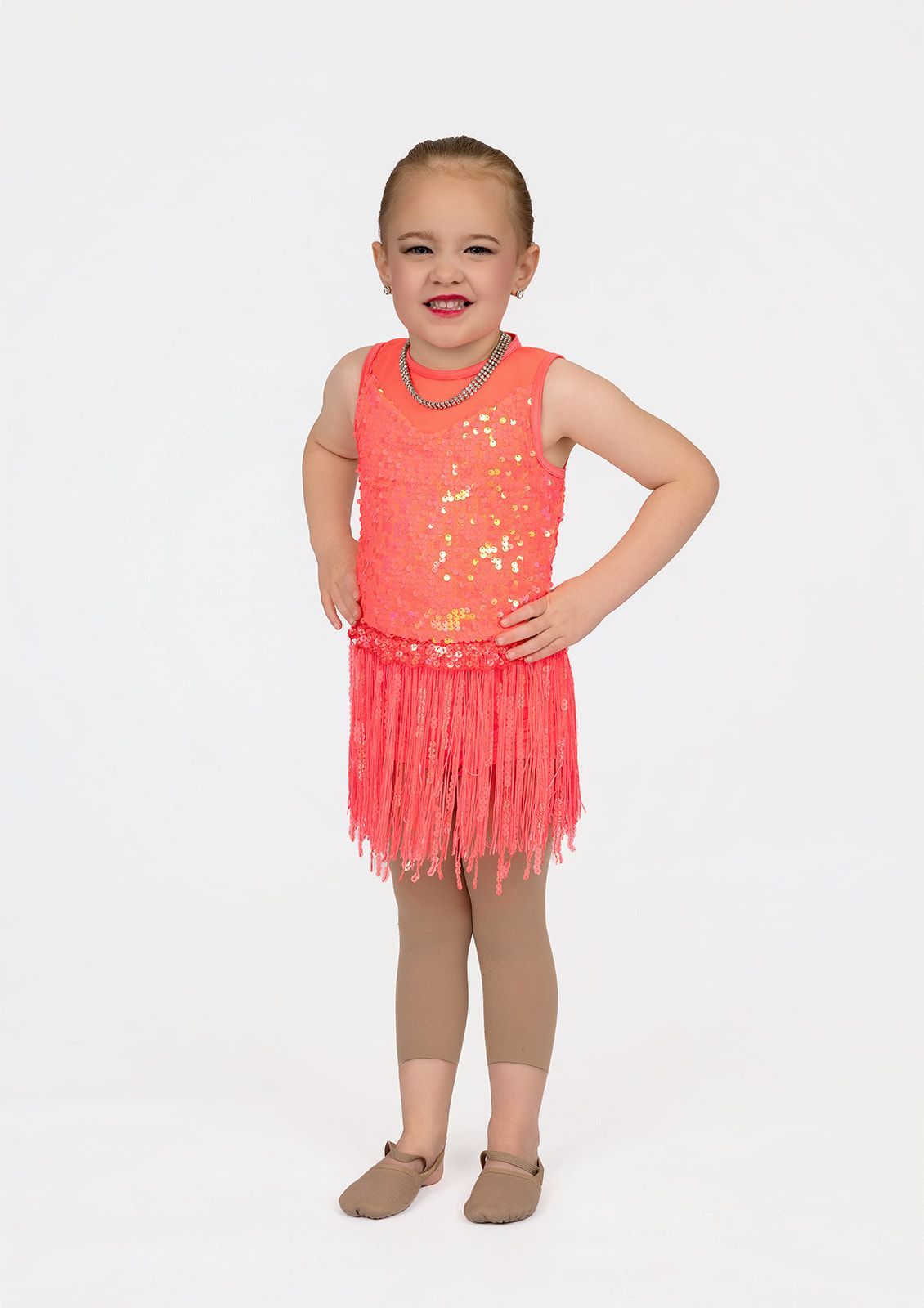 A little girl is wearing a blue leotard and a blue tutu.