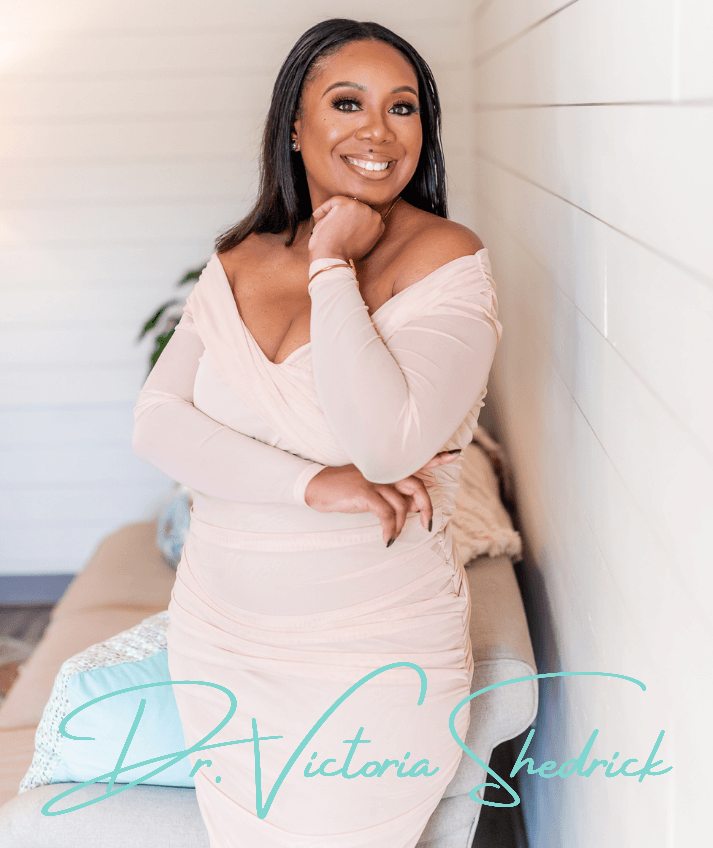 Woman in pink dress smiles, leaning against a couch, arm on chin. Text