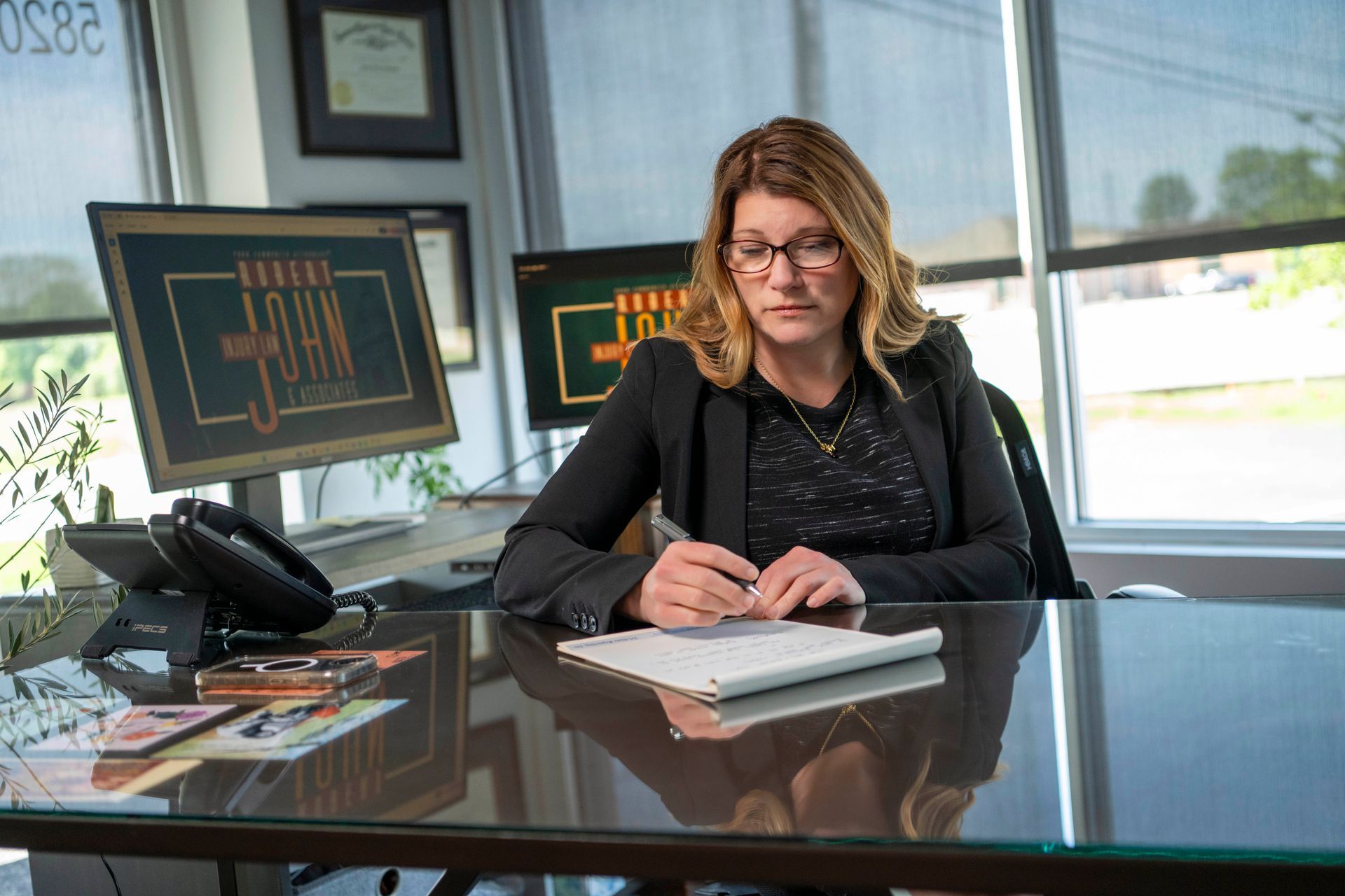 Evansville brain injury attorney reviewing case notes at Robert John & Associates