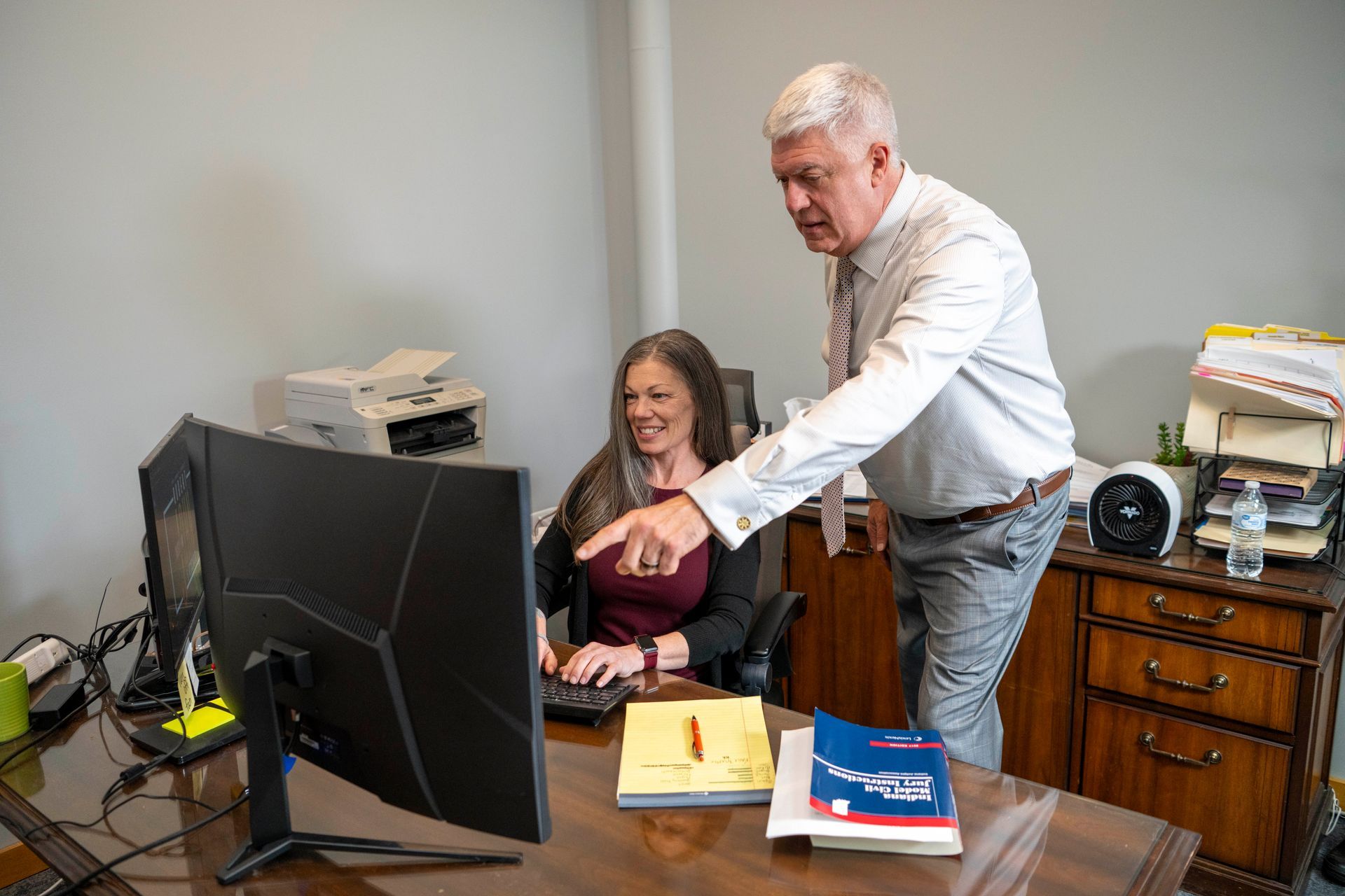 Evansville slip and fall attorney reviewing a case with staff at Robert John & Associates