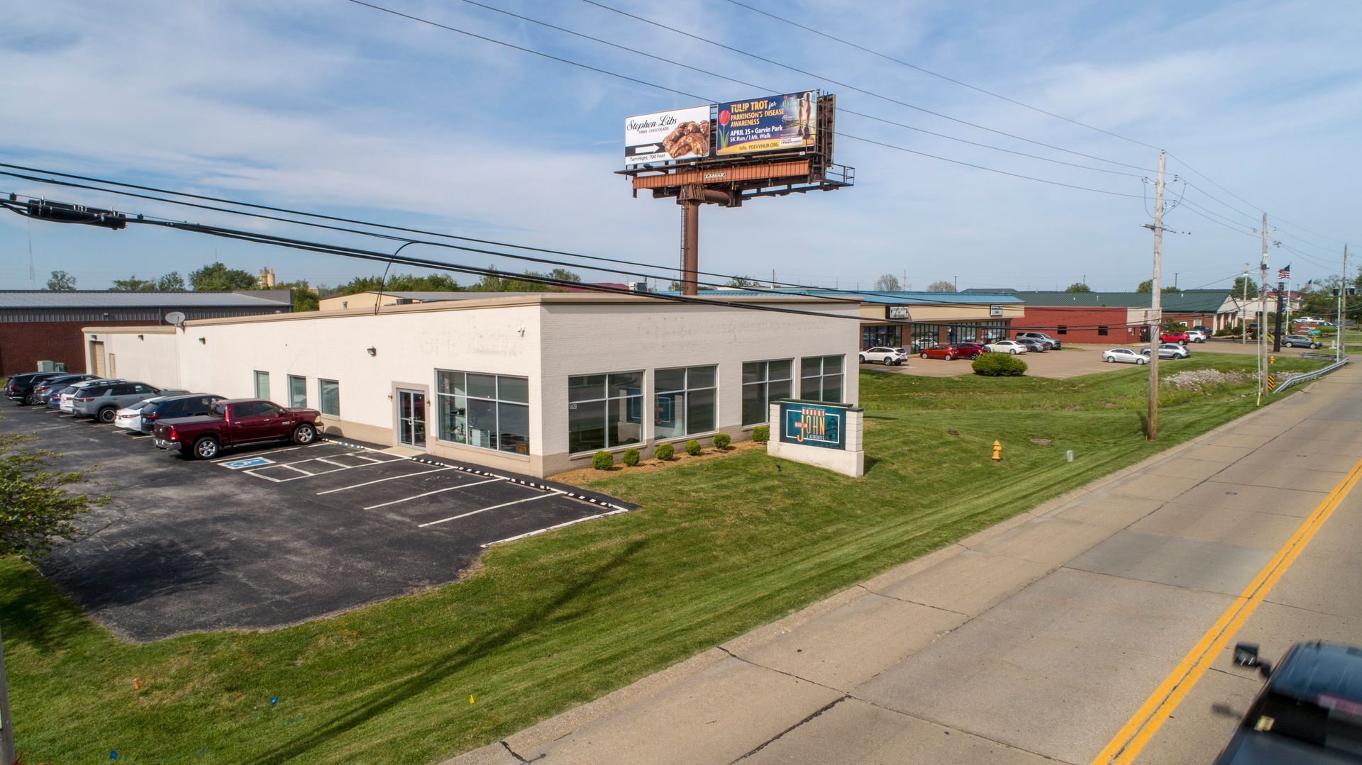 Aerial exterior view showing the Robert John & Associates office and nearby roadway.