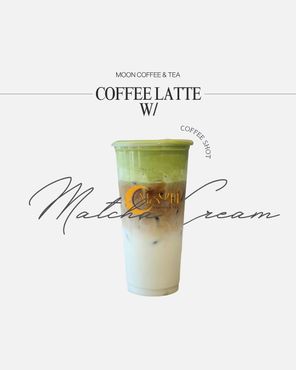 Lavender-topped iced latte in a clear cup on a sunlit table, with a blurred indoor café background
