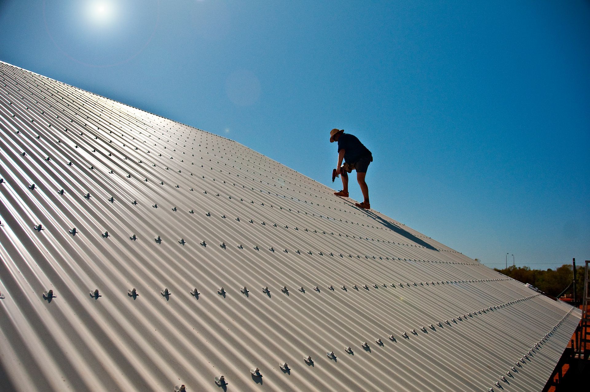A man is working on the roof of a building