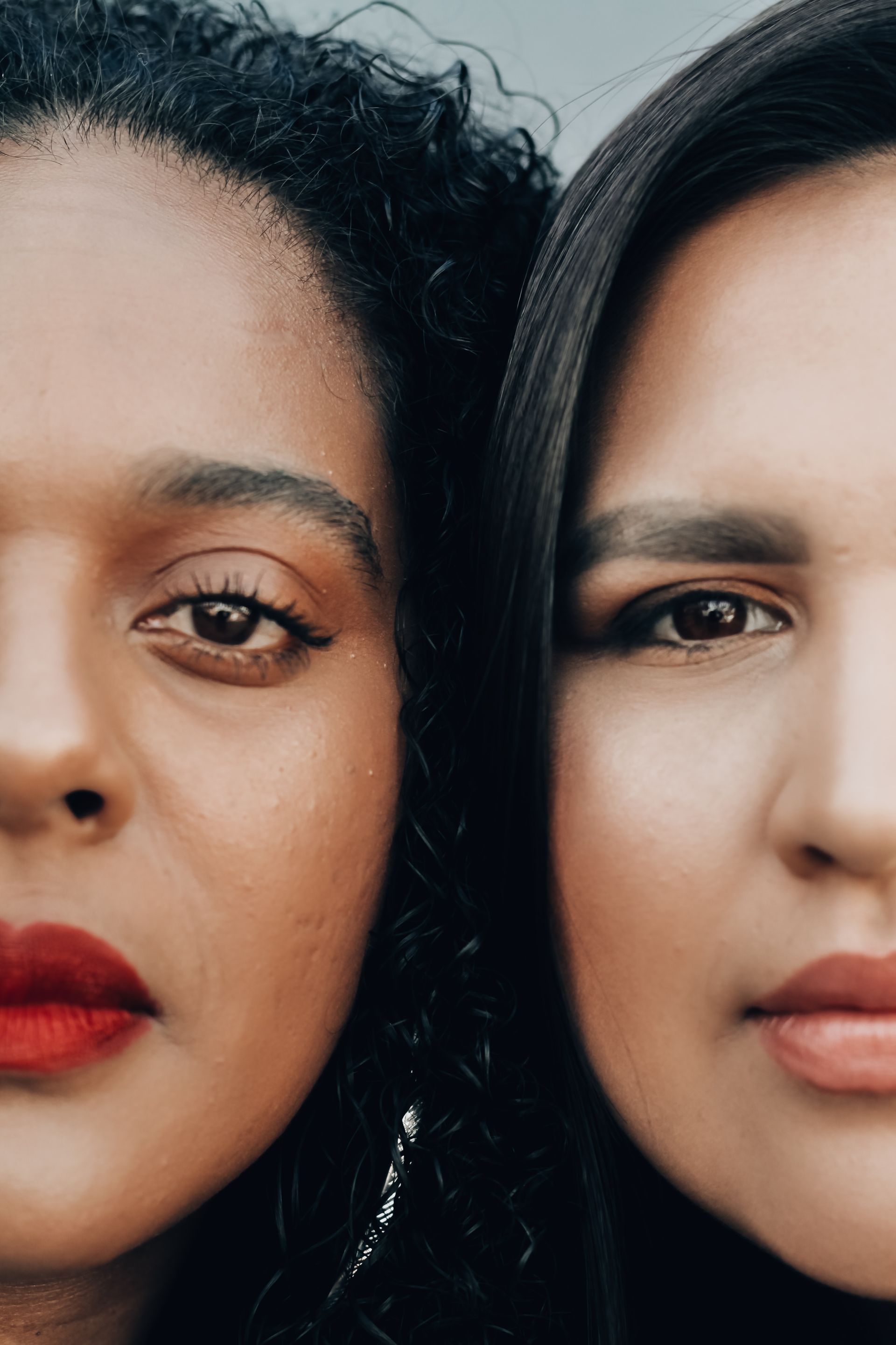 Two women are standing next to each other and looking at the camera.