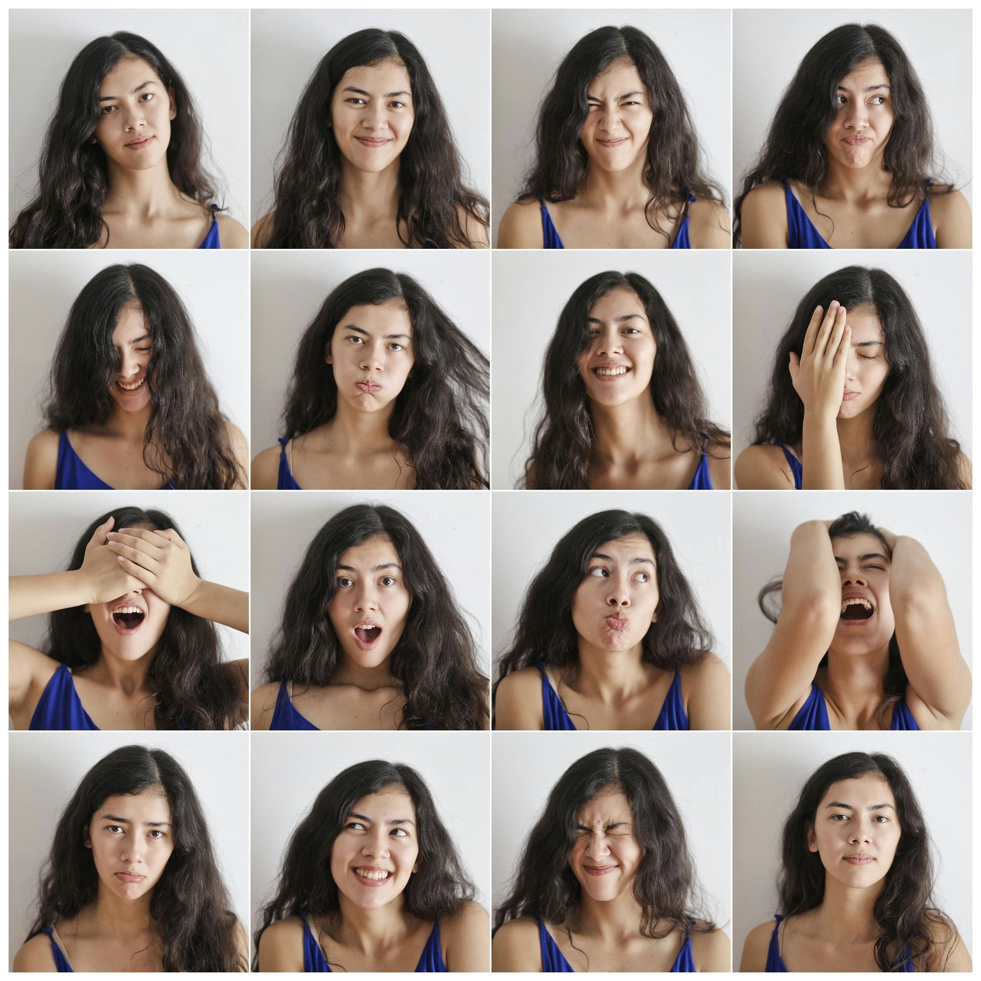 A woman in a blue tank top is making many different faces.