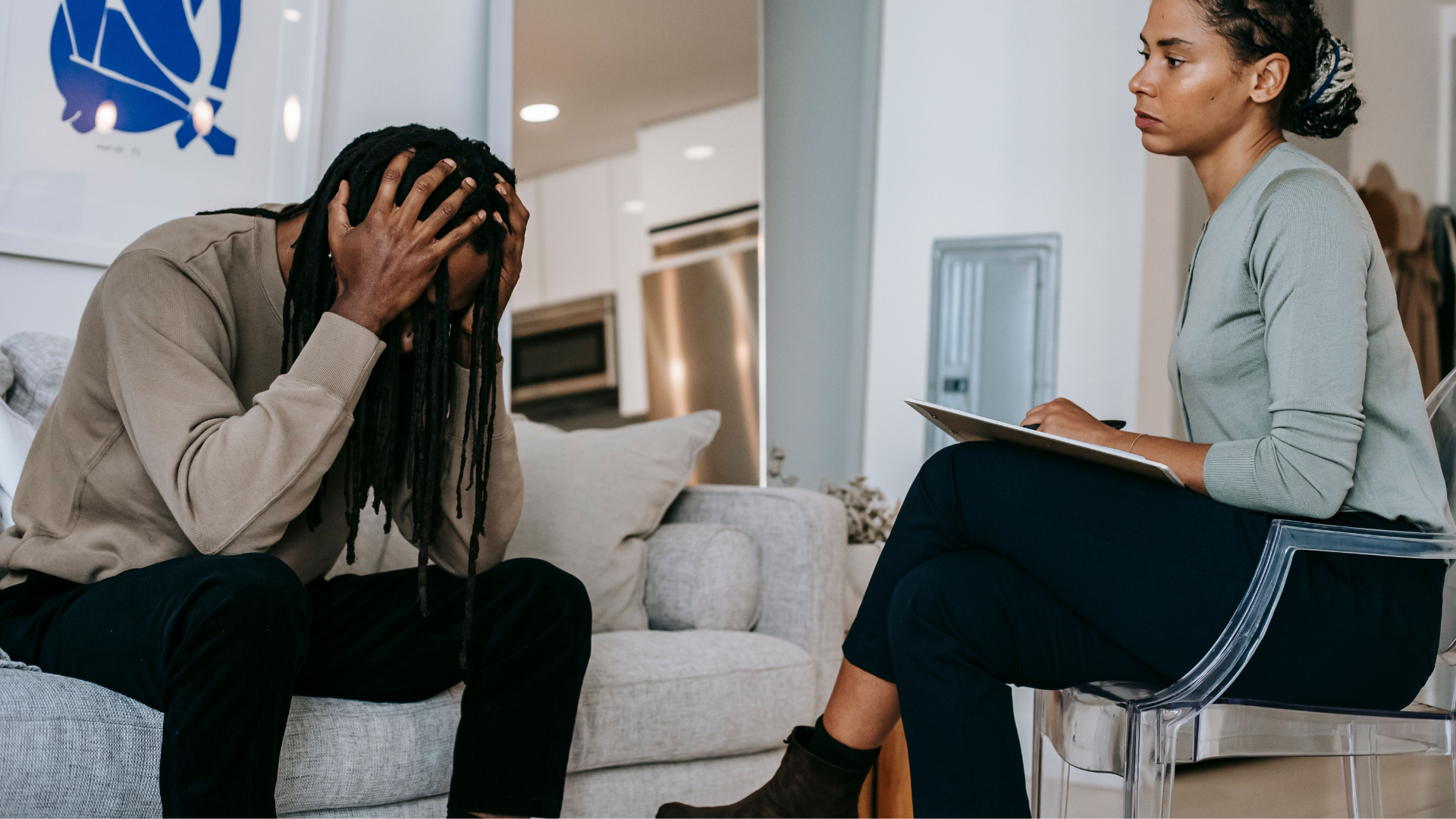 Doctor comforting a distressed patient on a couch during a counseling session