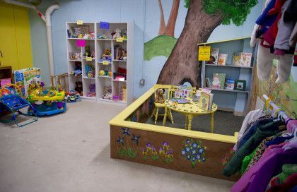 A room filled with lots of toys and a sandbox.