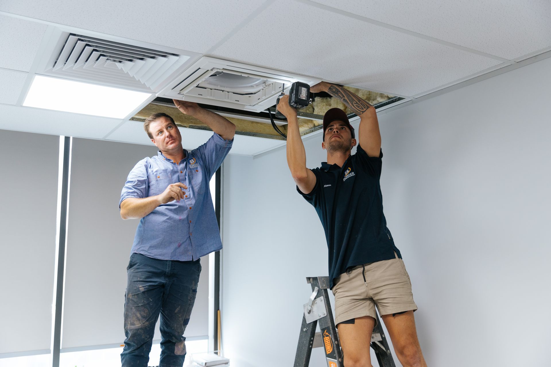 Border heating & cooling installation team member next to van