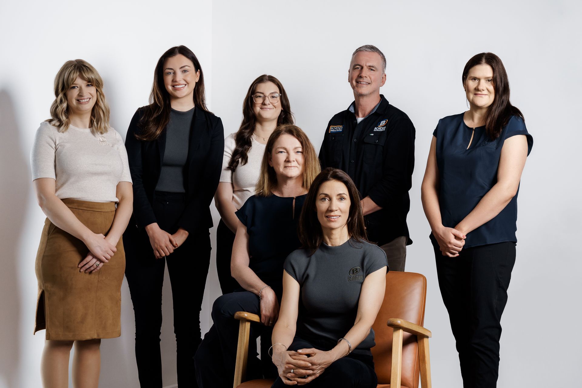The customer care team smiling for a photo