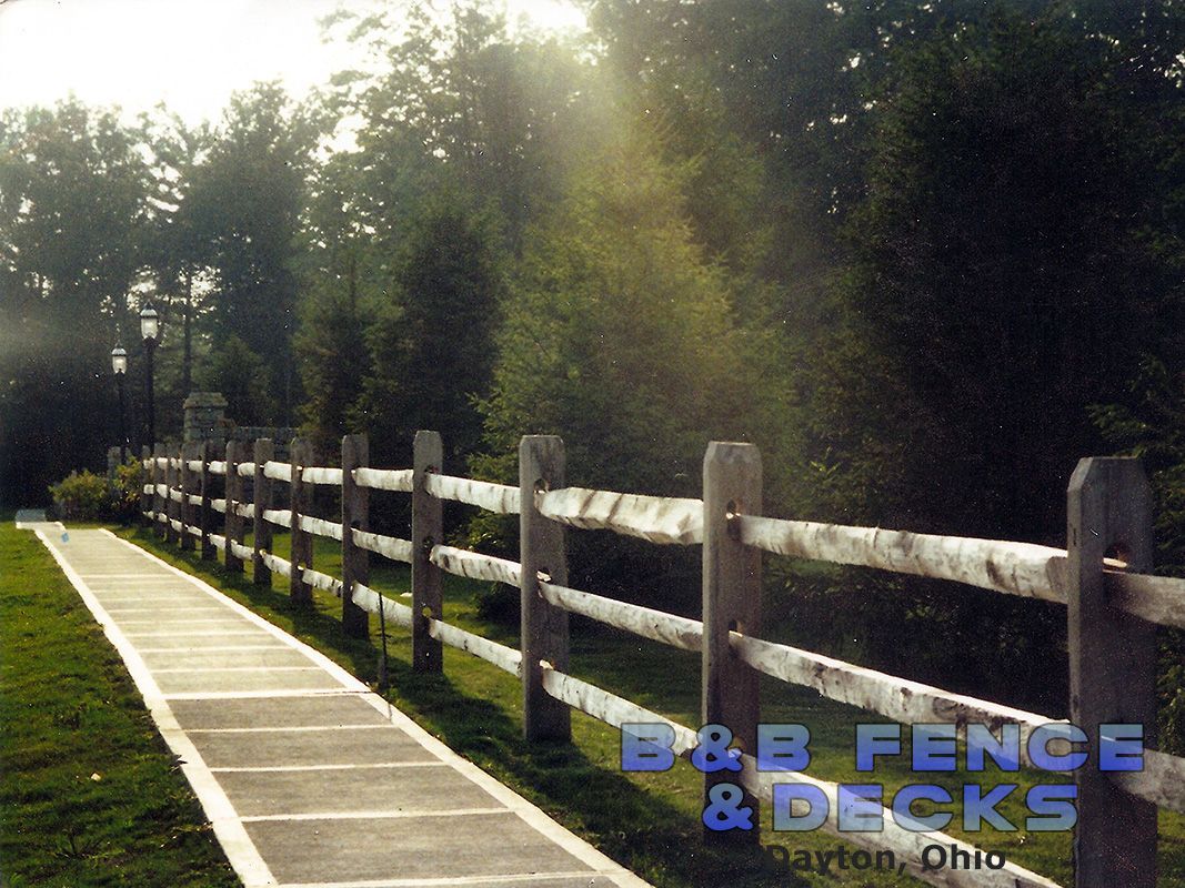 A Wooden Fence Along a Sidewalk — Dayton, OH — B & B Fence & Decks LLC