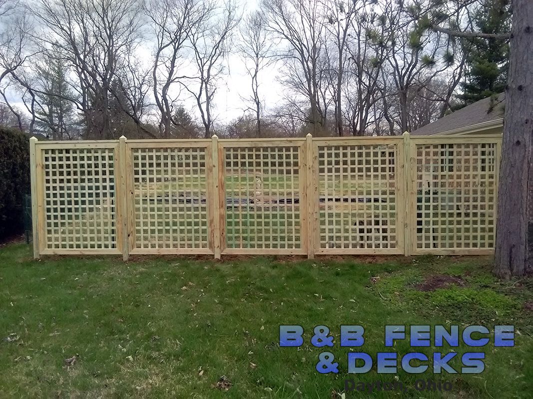 Wooden Fence With Trellis and Dried Trees — Dayton, OH — B & B Fence & Decks LLC