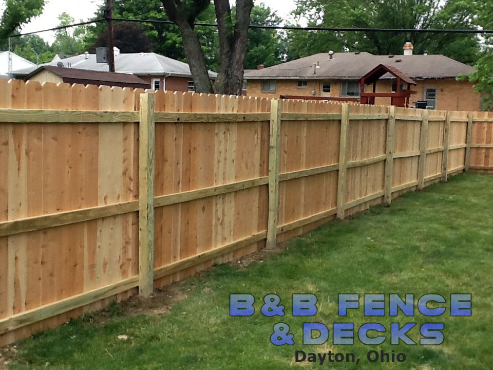 Wooden Fence With Trees and House — Dayton, OH — B & B Fence & Decks LLC