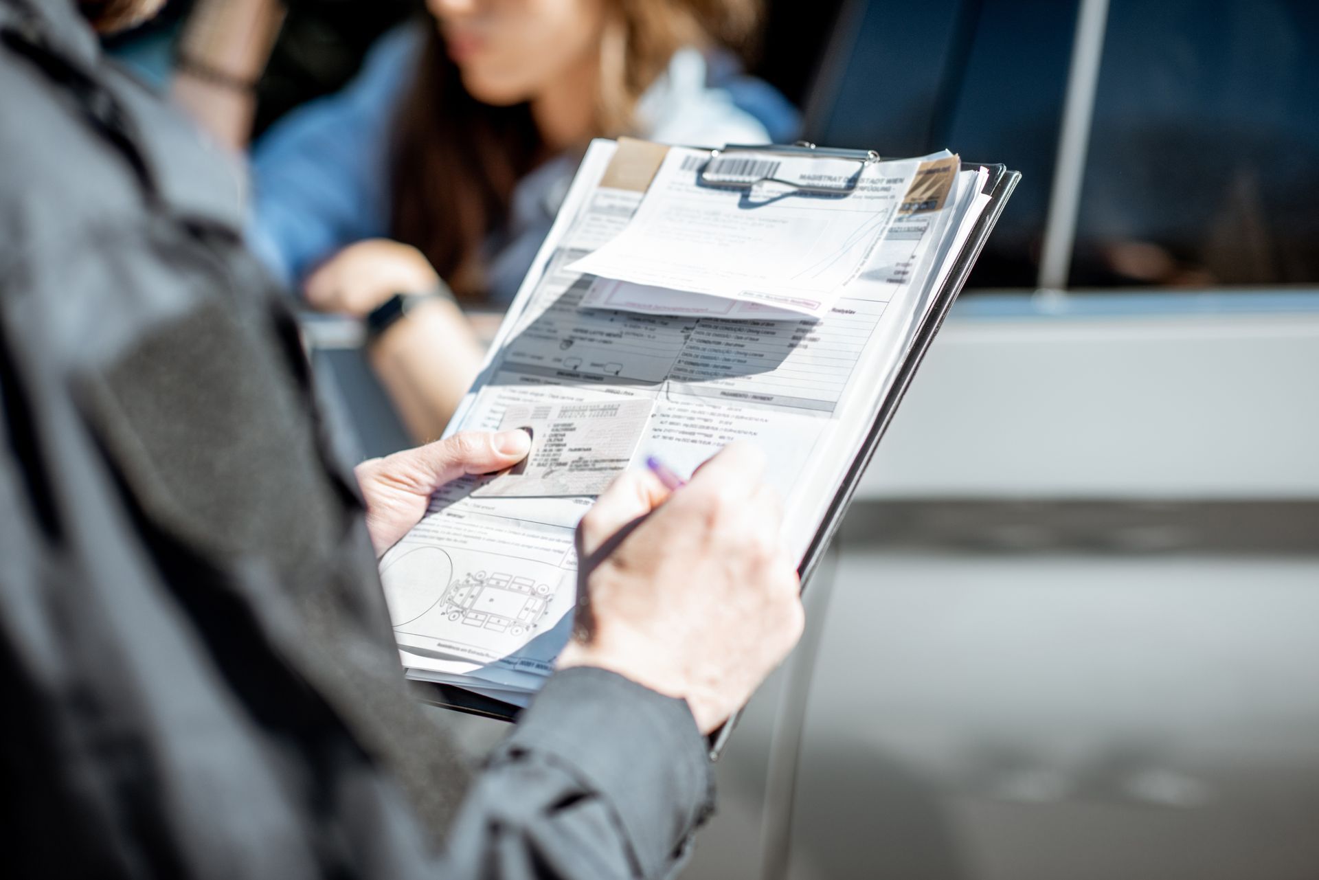 person filling out vehicle claim