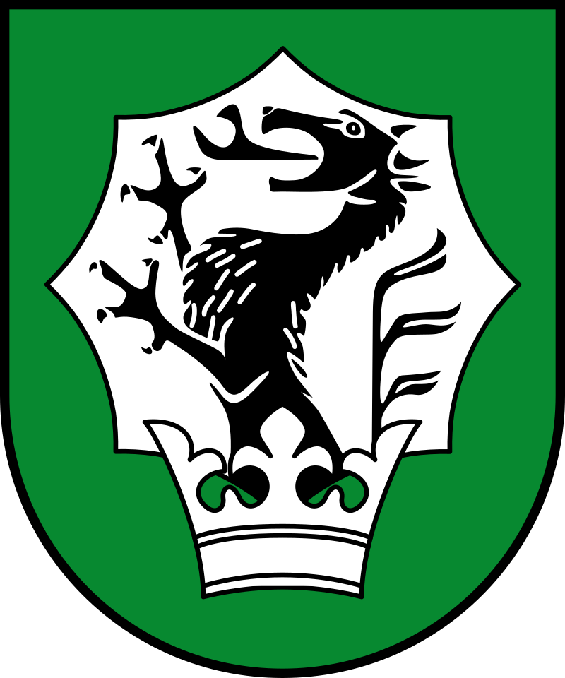 Grünes Schildemblem mit schwarzem Hirsch und weißem Zierkamm