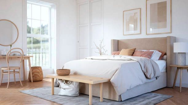 A bedroom with a bed , desk , chair , mirror and window.