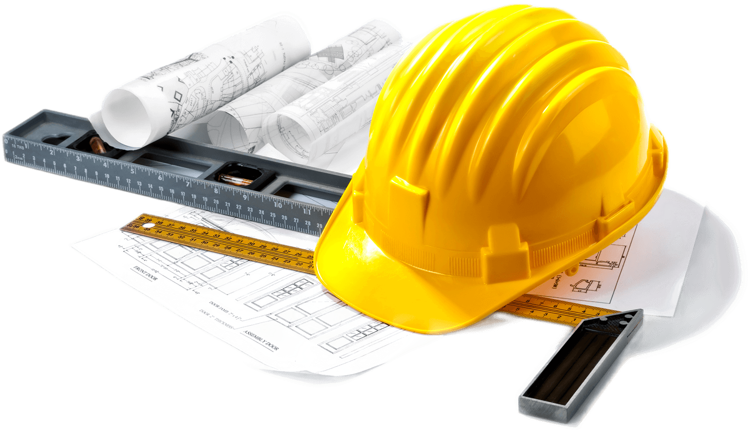 A yellow hard hat is sitting on top of a piece of paper next to a ruler.
