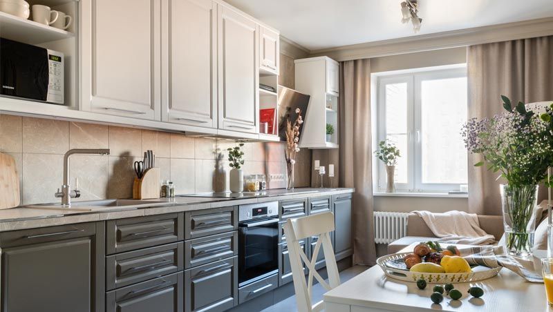 A kitchen with a table and chairs and a window.