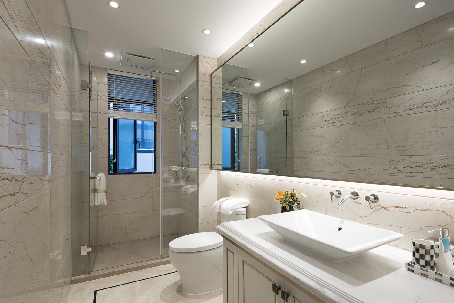 A bathroom with a toilet , sink , and shower.