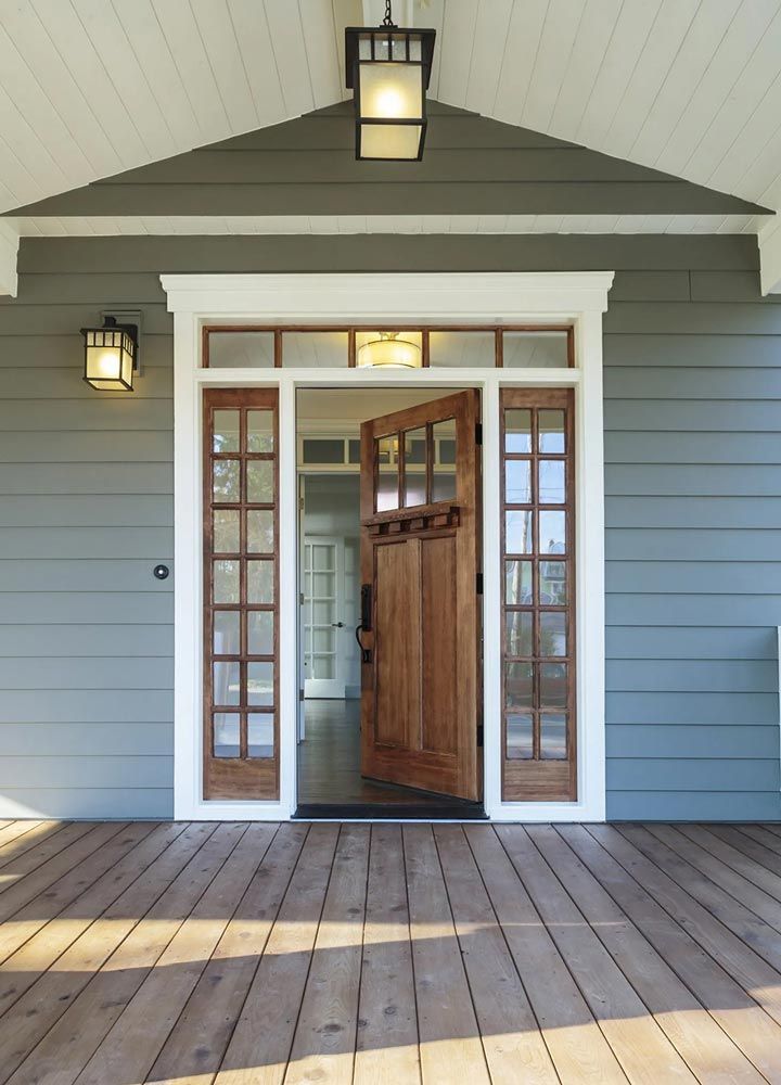 The front door of a house with a wooden deck