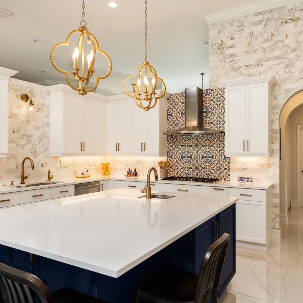 A kitchen with white cabinets and a blue island