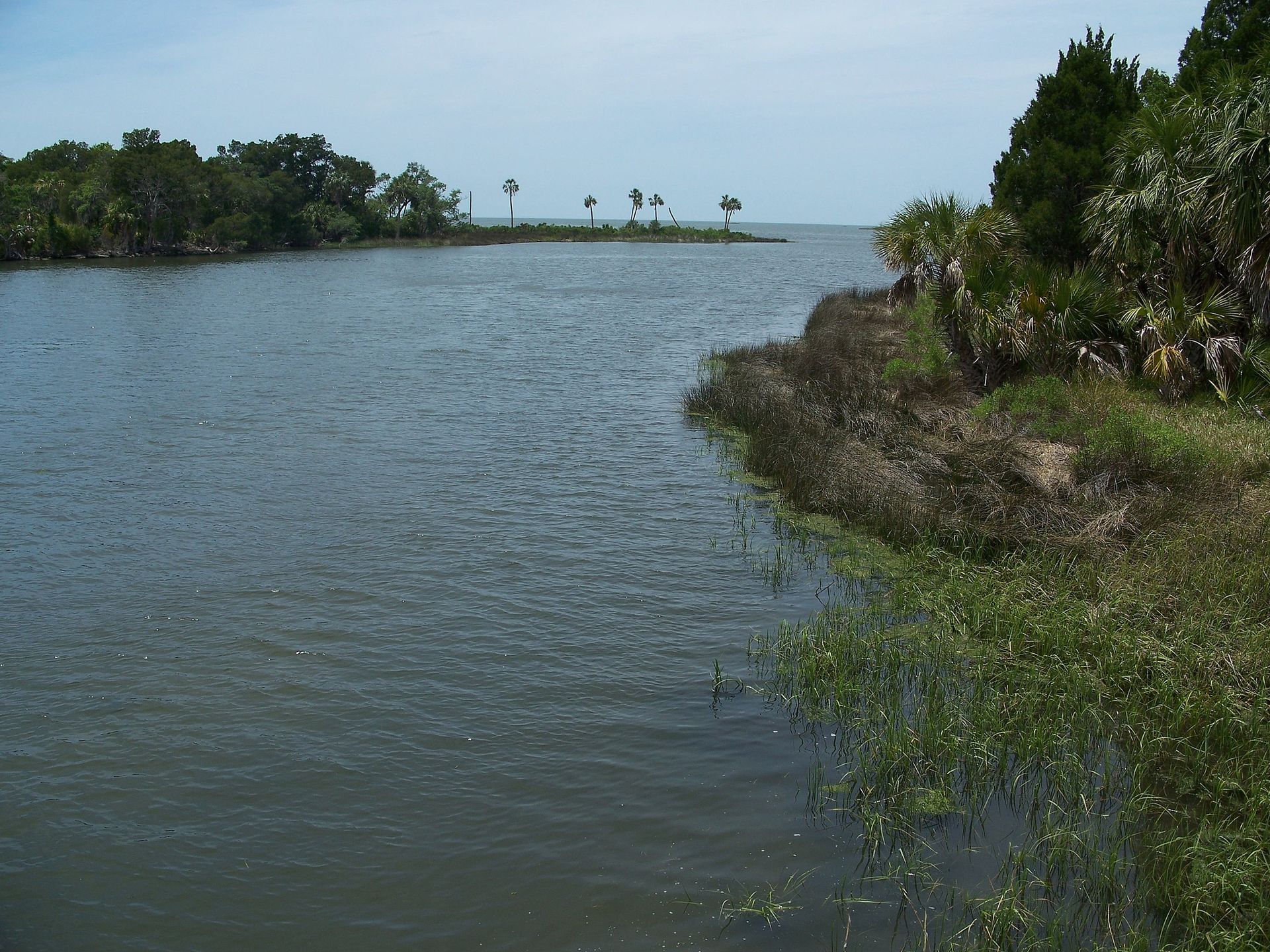 A small island in the middle of a large body of water